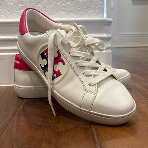 Tory Burch sneakers with pink and blue motifs.